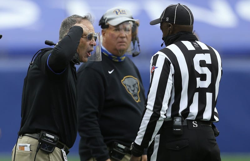 Pat Narduzzi and Mark Whipple talking to official