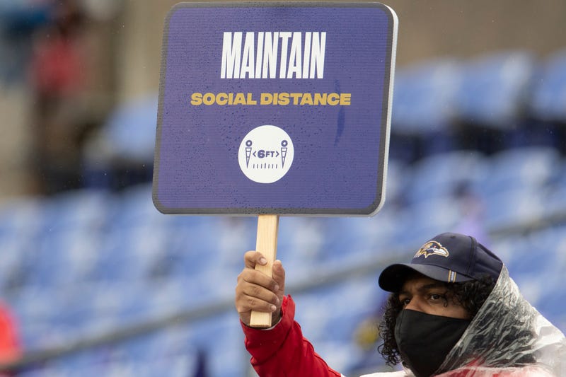 An usher a M&T Bank Stadium reminds fans to 'maintain social distance' during last month's Steelers/Ravens game