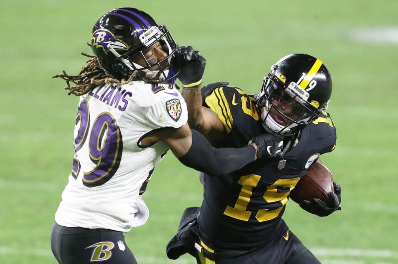 Steelers WR Juju Smith-Schuster stiff arms Ravens DB Tramon Williams during Baltimore's 19 to 14 loss to Pittsburgh