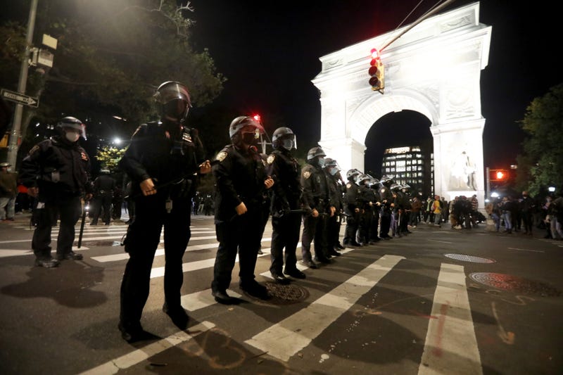 Members of the NYPD stand outside Washington Square Park in Manhattan after police broke up a march in Greenwich Village in Manhattan Nov. 4, 2020
