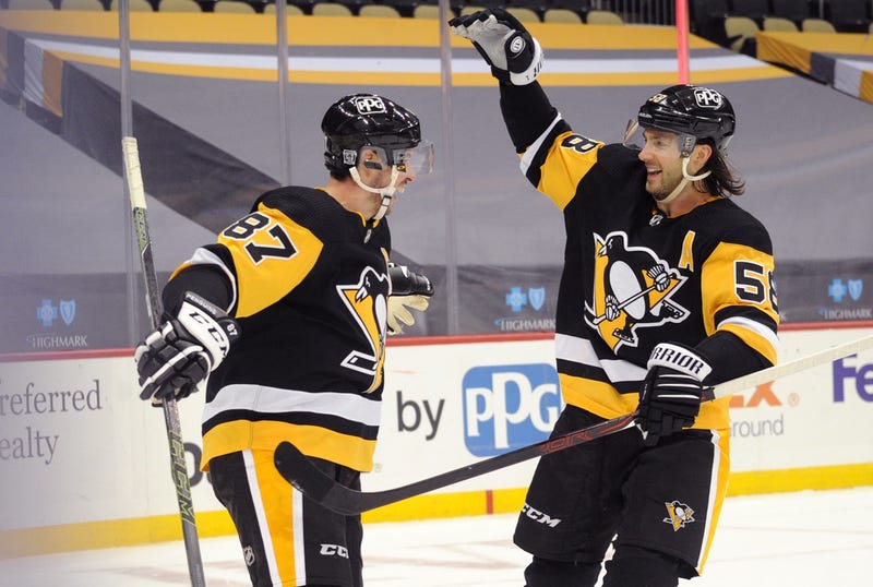 enguins center Sidney Crosby (87) celebrates his game winning goal in overtime with defenseman Kris Letang