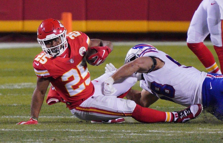 Kansas City Chiefs running back Clyde Edwards-Helaire (25) is tackled by Buffalo Bills outside linebacker Matt Milano (58) during the second quarter in the AFC Championship Game at Arrowhead Stadium.