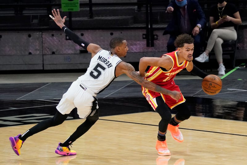 Apr 1, 2021; San Antonio, Texas, USA; Atlanta Hawks guard Trae Young (11) dribbles up court as San Antonio Spurs guard Dejounte Murray (5) reaches in for a foul in the fourth quarter at AT&T Center.