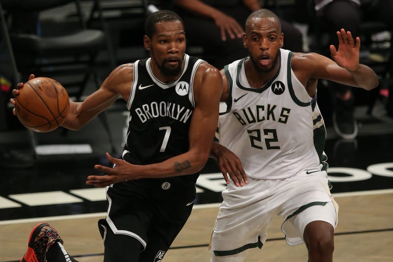 Nets star Kevin Durant guarded by Bucks star Khris Middleton.