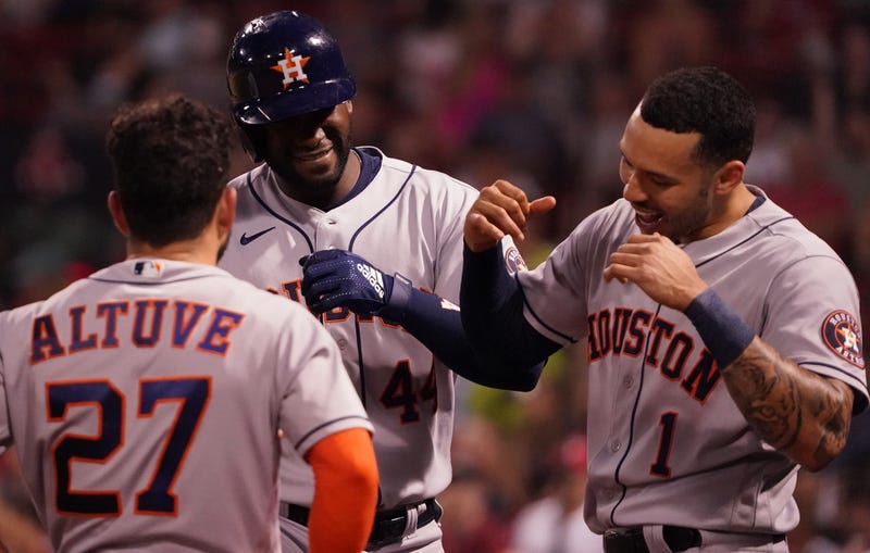Houston Astros designated hitter Yordan Alvarez (44) is congratulated by shortstop Carlos Correa (1) and second baseman Jose Altuve (27) after hitting a home run against the Boston Red Sox.