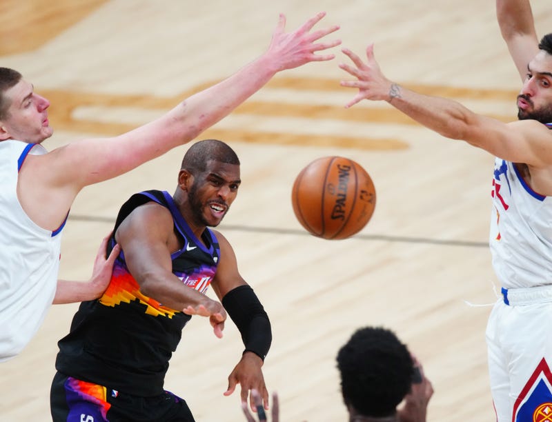 Phoenix Suns veteran Chris Paul passes the ball in traffic.