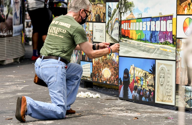 Gino Grossi takes a photo of part of the memorial at Pulse in downtown Orlando