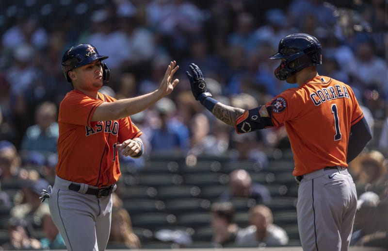 Houston Astros third baseman Aledmys Diaz (16) is congratulated by shortstop Carlos Correa (1) after scoring a run on hit by first baseman Yuli Gurriel (10) during the sixth inning.