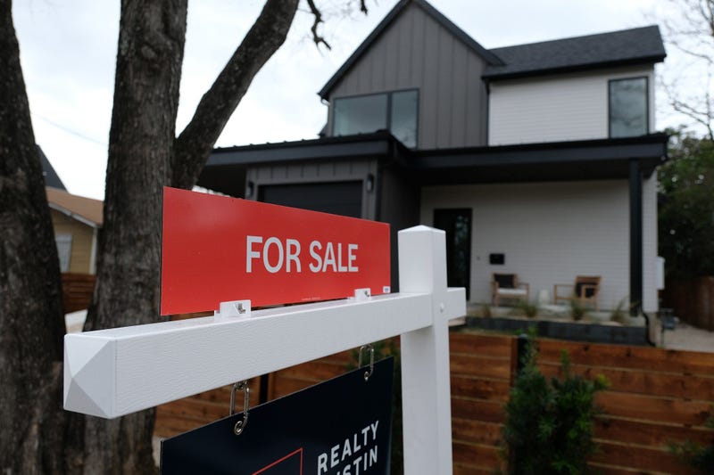 For Sale sign in front of house