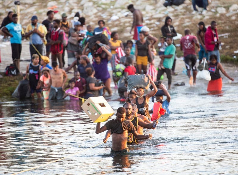 Haitian migrants cross the Rio Grande