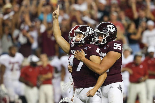 Texas A&M punter Nik Constantinou and kicker Seth Small celebrate victory over Alabama