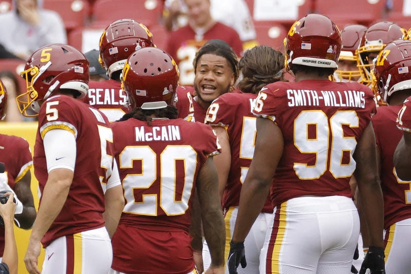 Washington Football Team defensive end Chase Young (99) talks to his during pregame warmups prior to their game against the New Orleans Saints at FedExField