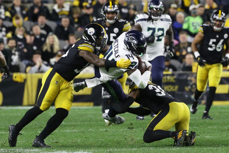 Seahawks wide receiver DK Metcalf (14) is tackled after a catch