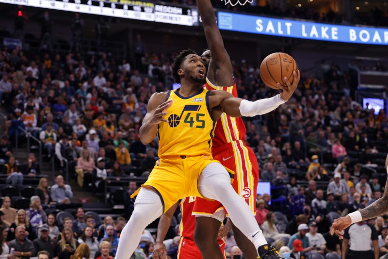 Nov 9, 2021; Salt Lake City, Utah, USA; Utah Jazz guard Donovan Mitchell (45) gets past Atlanta Hawks center Clint Capela (15) and under the basket during the third quarter at Vivint Arena. Utah Jazz won 110-98.