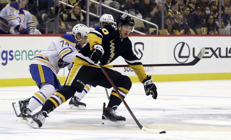 Drew O'Connor battling a Sabres player