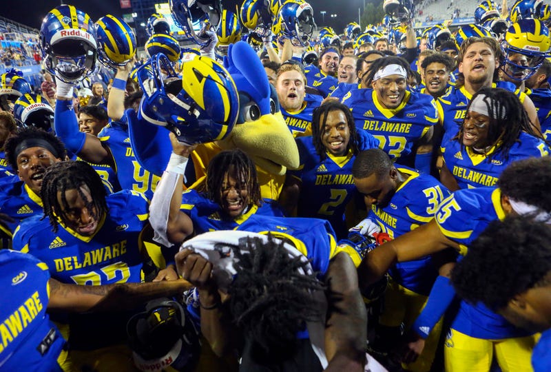 The Delaware Blue Hens gather in front of the University of Delaware Marching Band to celebrate the Hens' 35-9 win against Delaware State at Delaware Stadium on Saturday, Sept. 10, 2022.