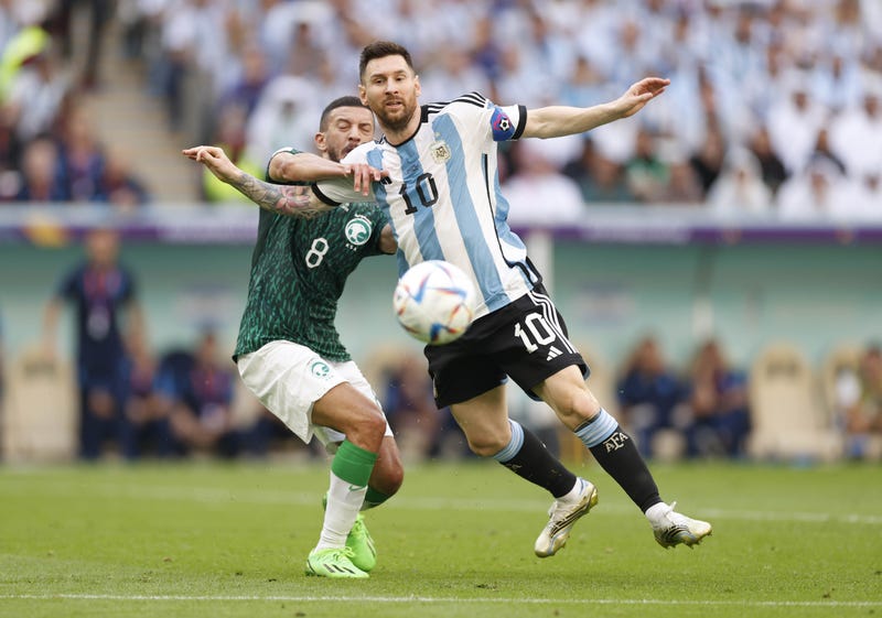 Argentina forward Lionel Messi (10) battles for the ball against Saudi Arabia midfielder Abdulellah Al-Malki (8)