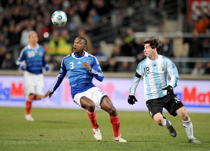 France player Eric Abidal (3) chases the ball against Argentina player Lionel Messi (18) during their World Cup qualifier match at Stade Velodrome. Argentina beat France 2-0.