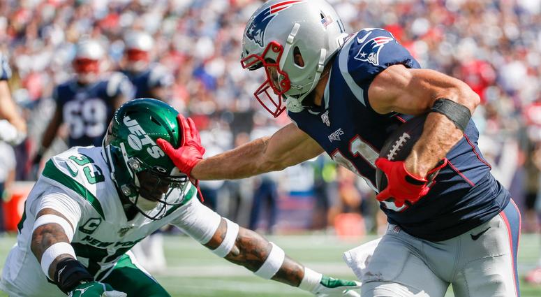 Patriots wide receiver Julian Edelman carries the ball as Jets safety Jamal Adams defends Sep 22, 2019; Foxborough, MA