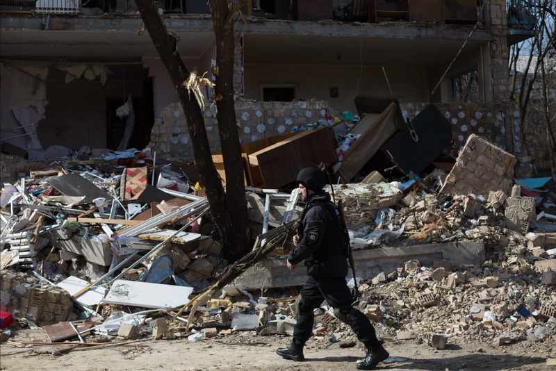 A police officer patrols a residential area which was destroyed as a result of a rocket strike two weeks ago on March 28, 2022 in Kyiv, Ukraine