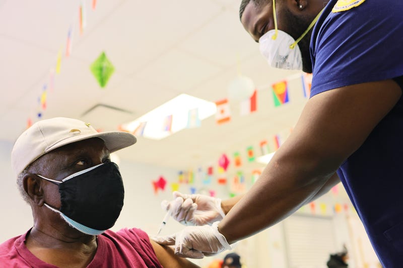 Robert Davis, 77, is given the Moderna coronavirus (COVID-19) vaccine by Kurtis Smith at Red Hook Neighborhood Senior Center in Brooklyn, NY, 2/22/21