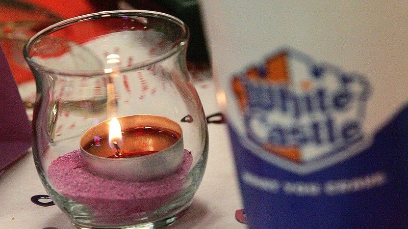 A candle is seen next to a White Castle soft-drink cup during a Valentine's Day dinner at a White Castle restaurant February 14, 2006 in Des Plaines, Illinois.
