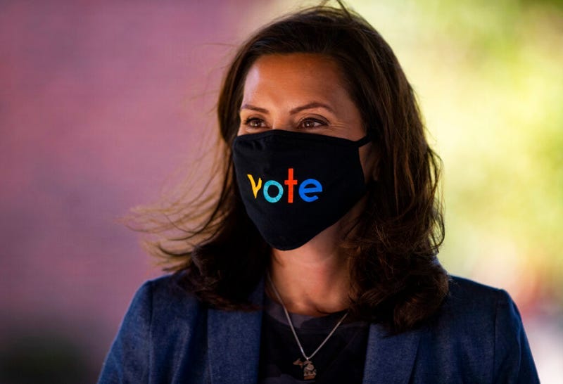 Michigan Gov. Gretchen Whitmer wears a mask with the word "vote" displayed on the front during a roundtable discussion on healthcare, Wednesday Oct. 7, 2020, in Kalamazoo, Mich. P