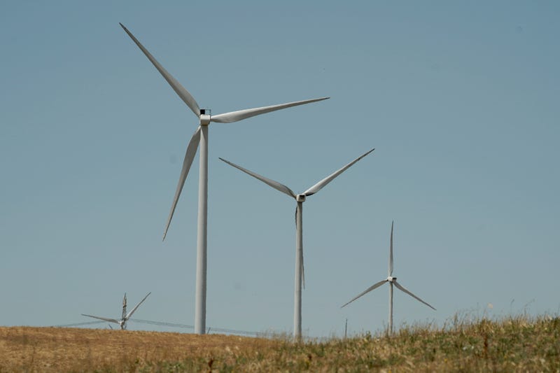 Wind turbines sit on a hill side near Rio Vista, Calif., on Monday, July 25, 2022. California Gov. Gavin Newsom wants to accelerate the state's transition to using clean sources like wind supple electricity in the state. It's part of his proposal to spend $19.3 billion of testate budget on climate policies.