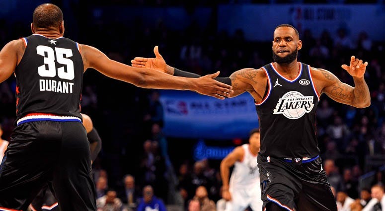Team LeBron forward LeBron James reacts with teammate Kevin Durant (35) during the NBA All-Star Game at the Spectrum Center in Charlotte, North Carolina.