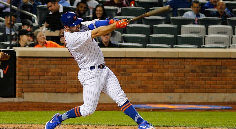 Mets first baseman Pete Alonso celebrates in the dugout after hitting a three-run homer against the Marlins on April 1, 2019, at Marlins Park in Miami.