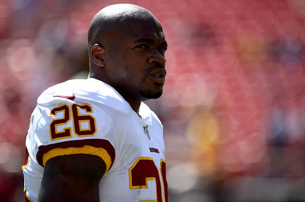 Adrian Peterson looks on before a Washington Redskins game.