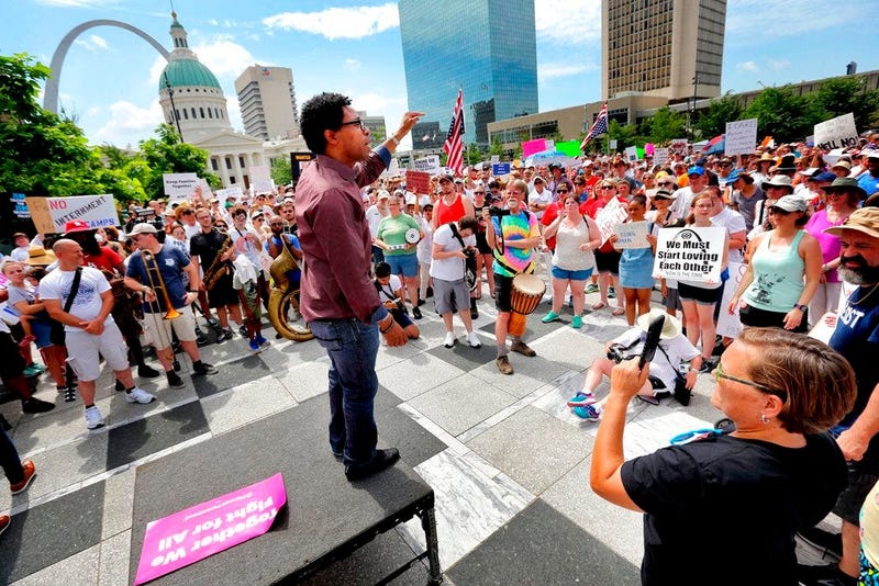 In this June 30, 2018, photo, Wesley Bell, a candidate for St. Louis County Prosecuting Attorney, addresses the crowd during a protest about the Trump Administration's policy of family separation and detention at Kiener Plaza in downtown St. Louis. St. Lo
