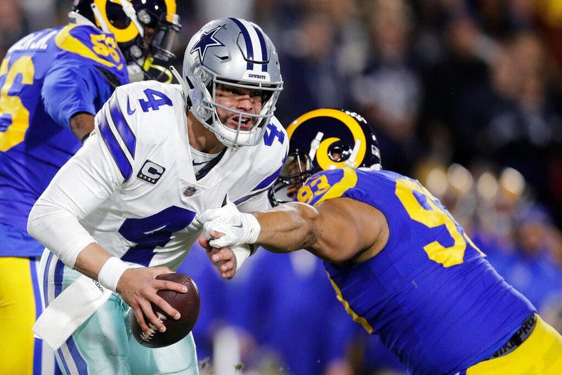 Dallas Cowboys quarterback Dak Prescott breaks away from Los Angeles Rams