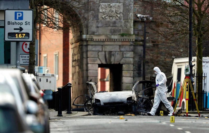 Forensic investigators at the scene of a car bomb blast on Bishop Street in Londonderry, Northern Ireland, Sunday, Jan. 20, 2019.