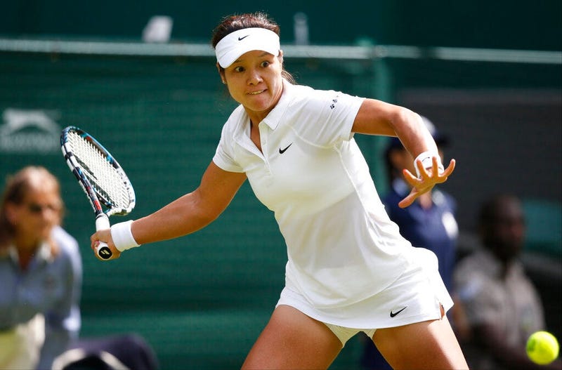Li Na of China plays a return to Paula Kania of Poland during their first round match at the All England Lawn Tennis Championships in Wimbledon, London