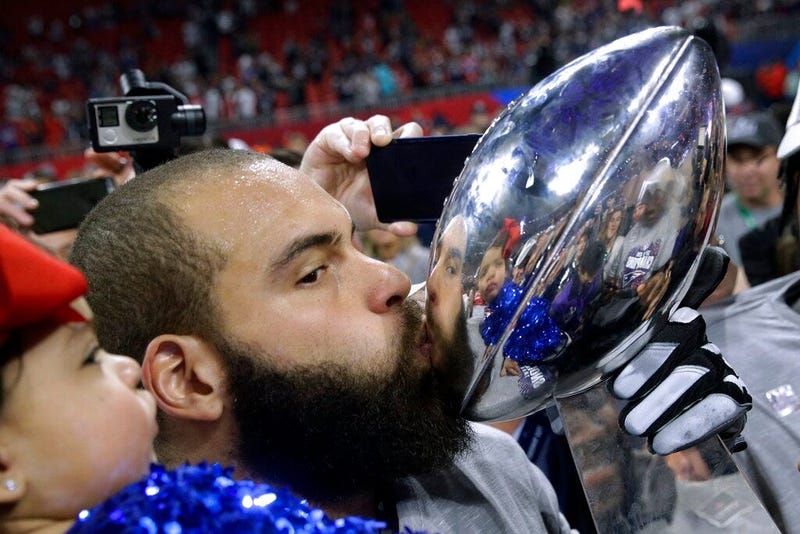 New England Patriots' Lawrence Guy kisses the trophy after the NFL Super Bowl 53 football game against the Los Angeles Rams, Sunday, Feb. 3, 2019, in Atlanta