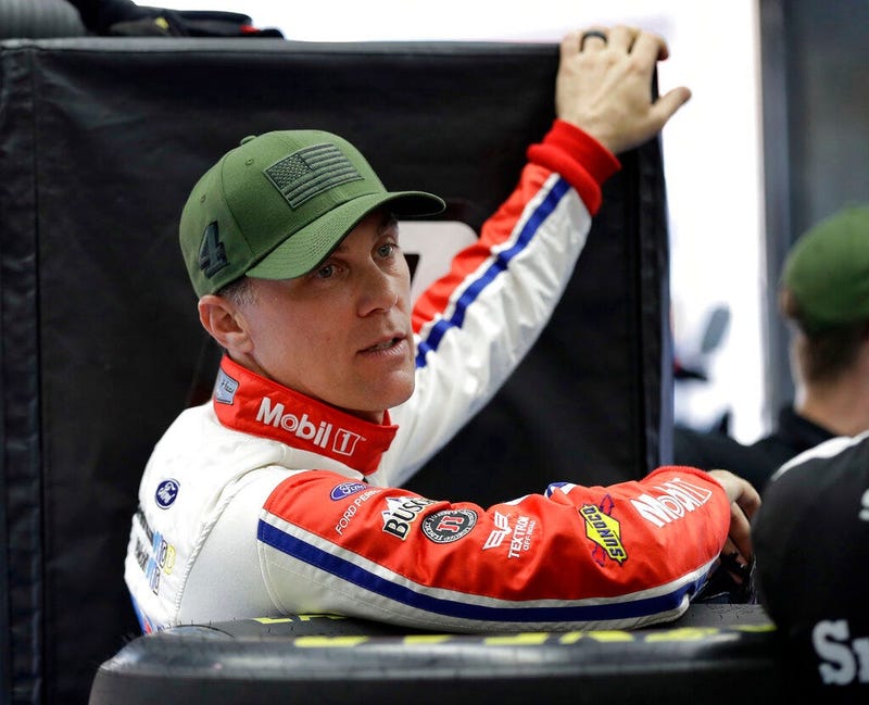 Kevin Harvick waits for his car to go through inspection before qualifying for the NASCAR Cup series auto race at Charlotte Motor Speedway in Charlotte, N.C.