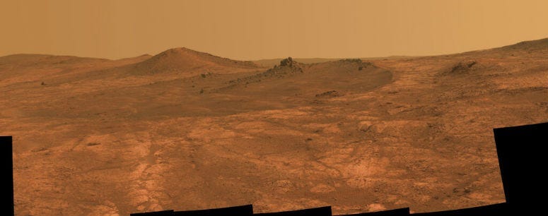 FILE - This composite of March 2015 photos made available by NASA shows a shallow crater called Spirit of St. Louis, about 110 feet (34 meters) long and about 80 feet (24 meters) wide, with a floor slightly darker than surrounding terrain.