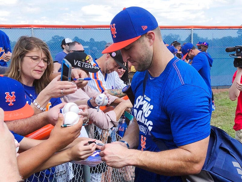 New York Mets' Tim Tebow signs autographs at spring training baseball practice Saturday, Feb. 16, 2019, in Port St. Lucie, Fla