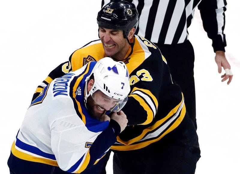 Boston Bruins defenseman Zdeno Chara (33) and St. Louis Blues left wing Pat Maroon (7) fight during the first period of an NHL hockey game, in Boston