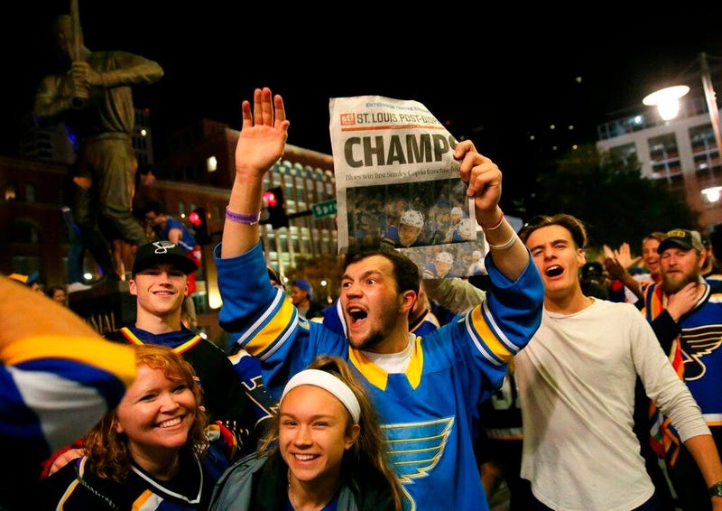 St. Louis Blues fans celebrate the team's victory over the Boston Bruins in Boston in Game 7 of the NHL hockey Stanley Cup Final, outside Busch Stadium in St. Louis after a watch party for the game was held in the baseball stadium Wednesday, June 12, 2019