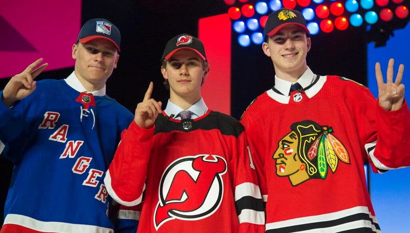 New York Rangers draft pick Kaapo Kakko, left; New Jersey Devils pick Jack Hughes, center; and Chicago Blackhawks pick Kirby Dach pose for photos during the first round of the NHL hockey draft