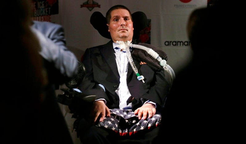Pete Frates, who is stricken with amyotrophic lateral sclerosis, or ALS, listens to a guest at Fenway Park in Boston