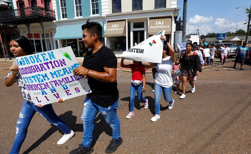 children of mainly Latino immigrant parents hold signs in support of them