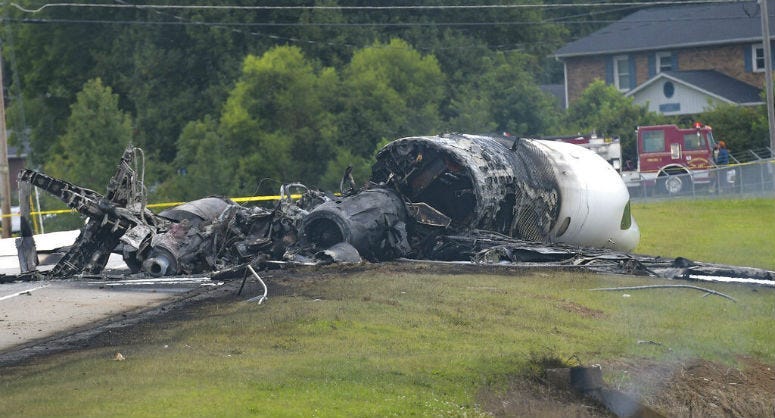 The burned remains of a plane that was carrying NASCAR television analyst and former driver Dale Earnhardt Jr. lie near a runway Thursday, Aug. 15, 2019, in Elizabethton, Tenn.