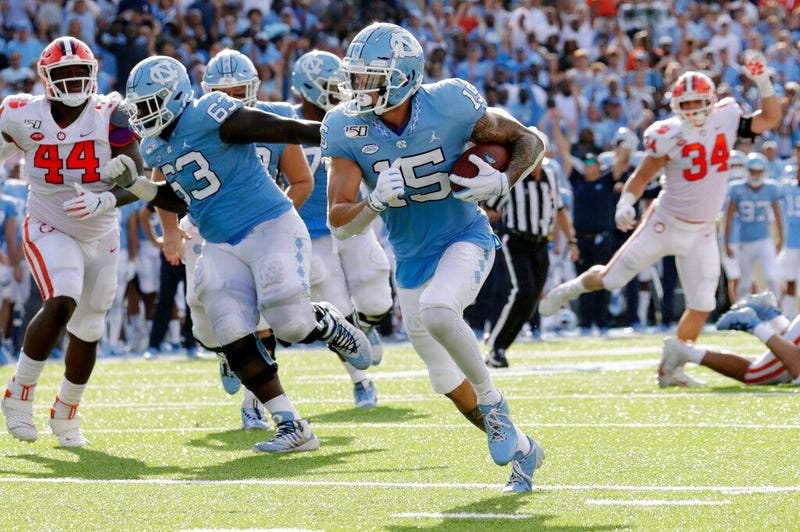 North Carolina's Beau Corrales (15) runs for a touchdown behind the block of Ed Montilus (63) while Clemson's Nyles Pinckney (44) looks on during the second quarter of an NCAA college football game in Chapel Hill, N.C., Saturday, Sept. 28, 2019.