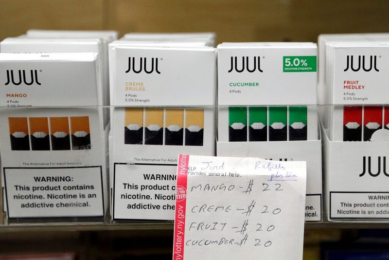 Juul products are displayed at a smoke shop in New York. On Thursday, Oct. 17, 2019, the company announced it will voluntarily stop selling its fruit and dessert-flavored vaping pods.