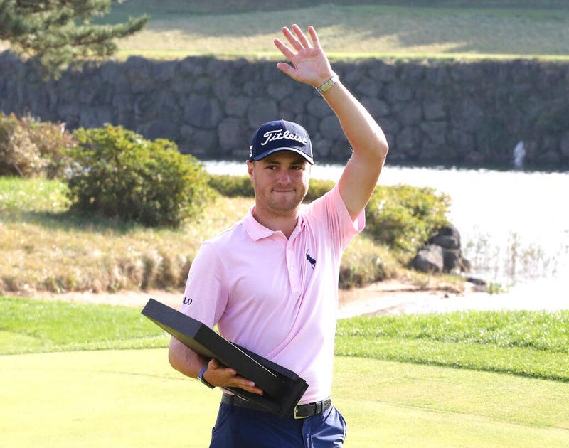 Justin Thomas of the United States waves with his trophy after winning the CJ Cup PGA golf tournament at Nine Bridges on Jeju Island, South Korea, Sunday, Oct. 20, 2019.