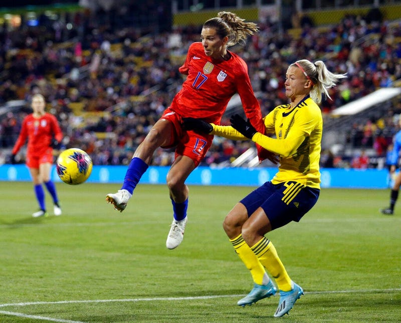 United States forward Tobin Heath, left, passes the ball in front of Sweden defender Hanna Glas during the first half of a women's international friendly soccer match in Columbus, Ohio, Thursday, Nov. 7, 2019.