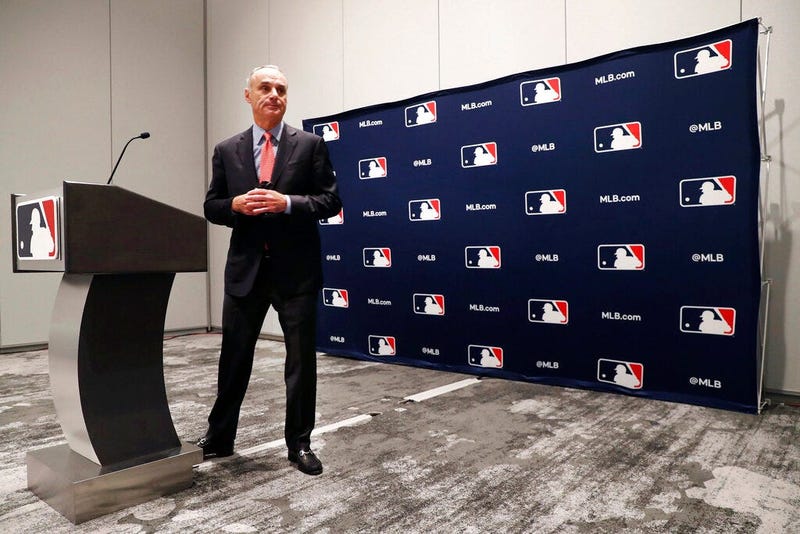 Baseball commissioner Rob Manfred steps away from the podium after speaking to the media at the owners meeting in Arlington, Texas, Thursday, Nov. 21, 2019.